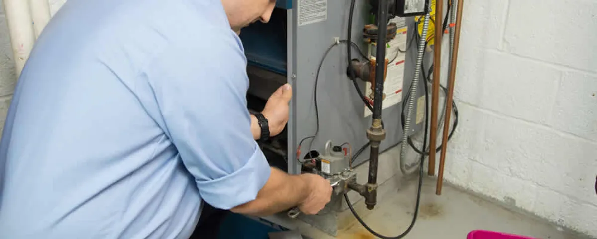 Furnace repair technician inspecting and servicing a home heating system in Naperville, IL