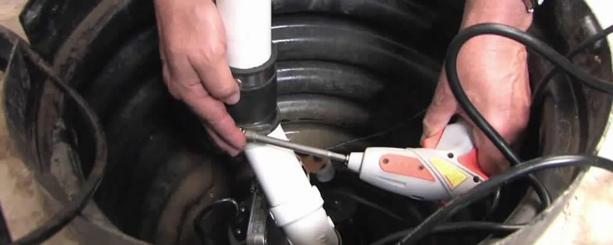 Sump pump installation technician connecting PVC discharge piping in Naperville, IL